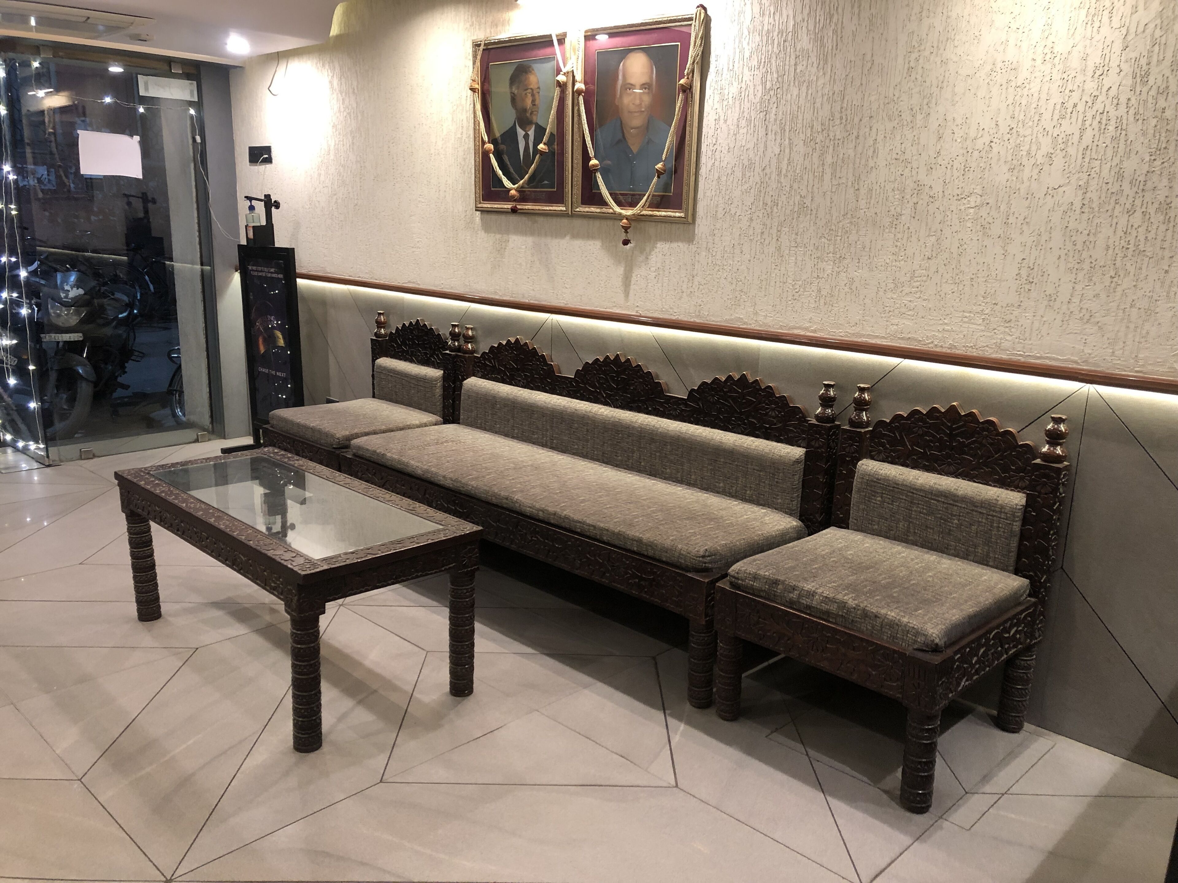 A modern lobby with a sofa and a glass-top coffee table.