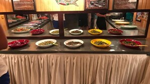 A buffet with various dishes displayed in bowls. - Divasa Hotel (Kumluca)