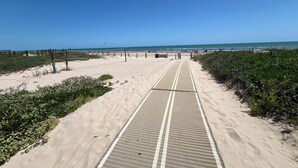 A beach pathway leading to the ocean with a clear sky. - Beachfront, Luxurious, Great Location with Amazing Views!!! (South Padre Island)