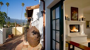 A patio with a stone floor, a large vase, and a fireplace. - Experience West Beach living, just steps away from Santa Barbara Harbor (Santa Barbara)