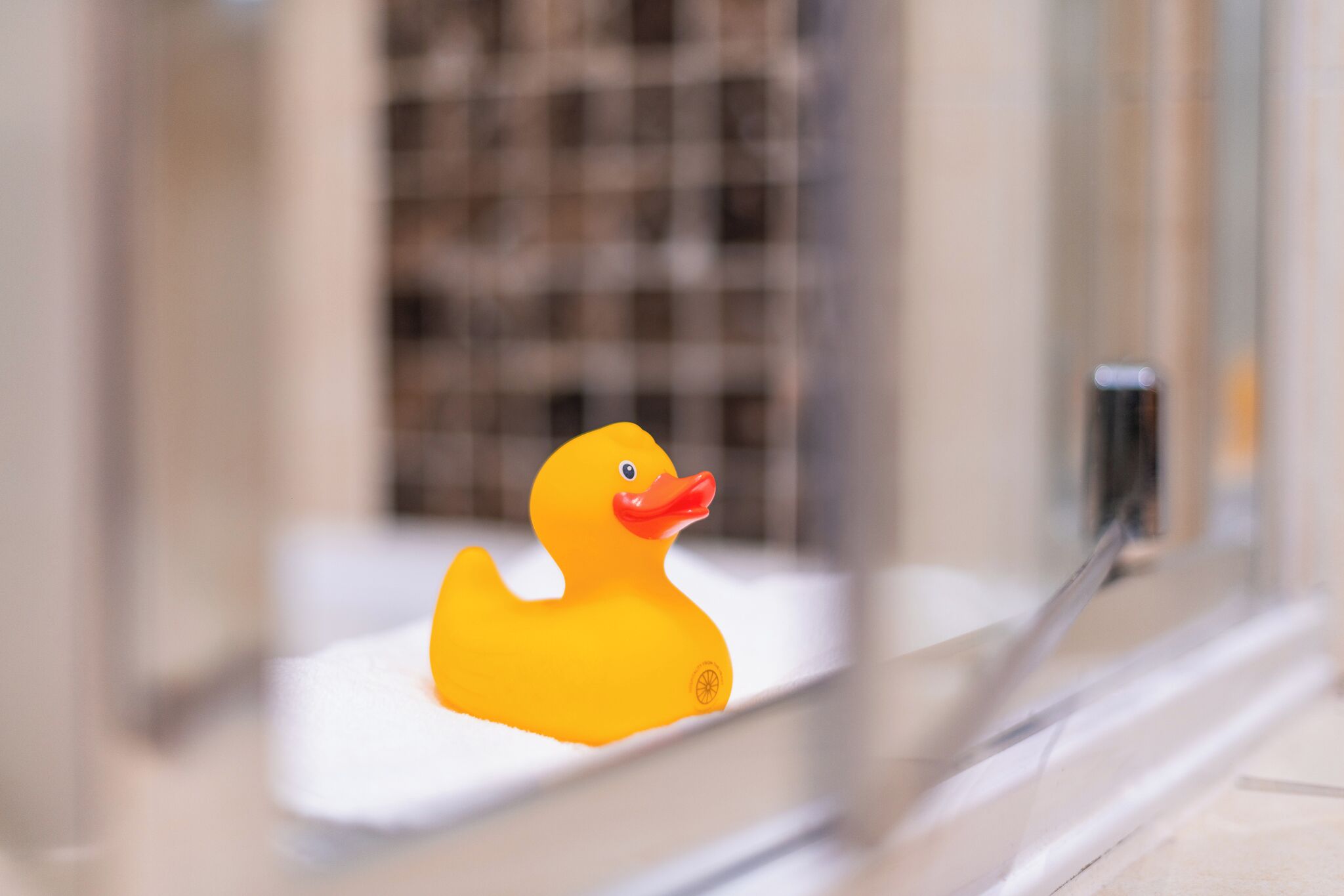 A yellow rubber duck in a bathtub.