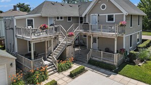 A two-story house with a balcony, a staircase, and a front porch.