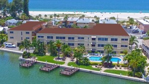 A hotel with a pool, a beach view, and a marina. - Come make a snowman out of sand in warm, sunny Florida! (Treasure Island)