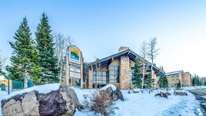 A lodge with a stone facade, large windows, and a prominent sign. - Heart of Rock-n-Roll (2303) | Amazing Views (Brian Head)