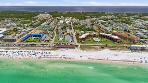 An aerial view of a coastal town with a beach, residential buildings, and a large hotel complex. - Gulfcrest unit 2. 1 Block From Beach!! Private Swimming Pool!! 2 Bed 2 Bath (Miramar Beach)
