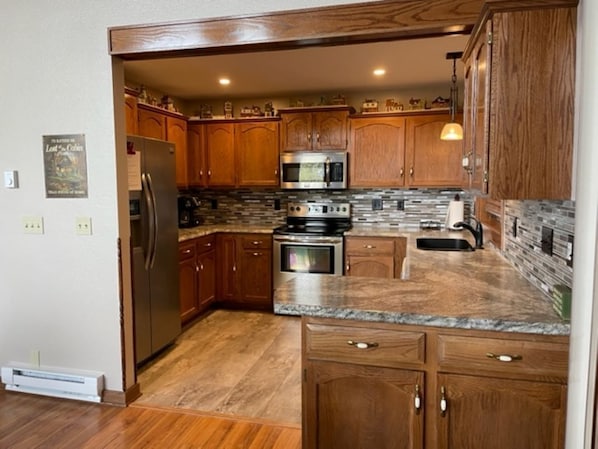 Enjoy cooking in this well-equipped kitchen with a refrigerator, microwave, and oven.