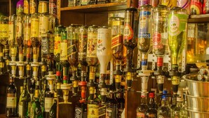 A bar with a variety of liquor bottles and a tap system. - Pepe Piatto (Dipaleseng)