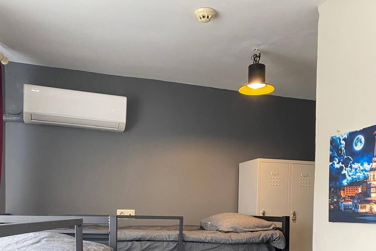 BED IN A BOYS' DORMITORY ROOM | In-room safe, desk, bed sheets