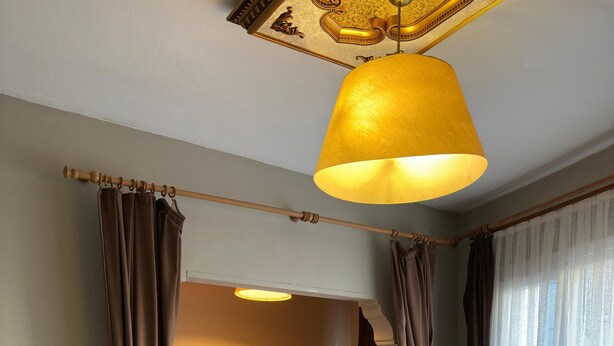 A hotel room with a bed, a chair, a table, and a large window with curtains. - Chez Bore  (Istanbul)