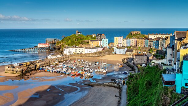 A coastal town with a marina, historic buildings, and a prominent fort overlooking the sea. - Royal Lion Hotel (Tenby)