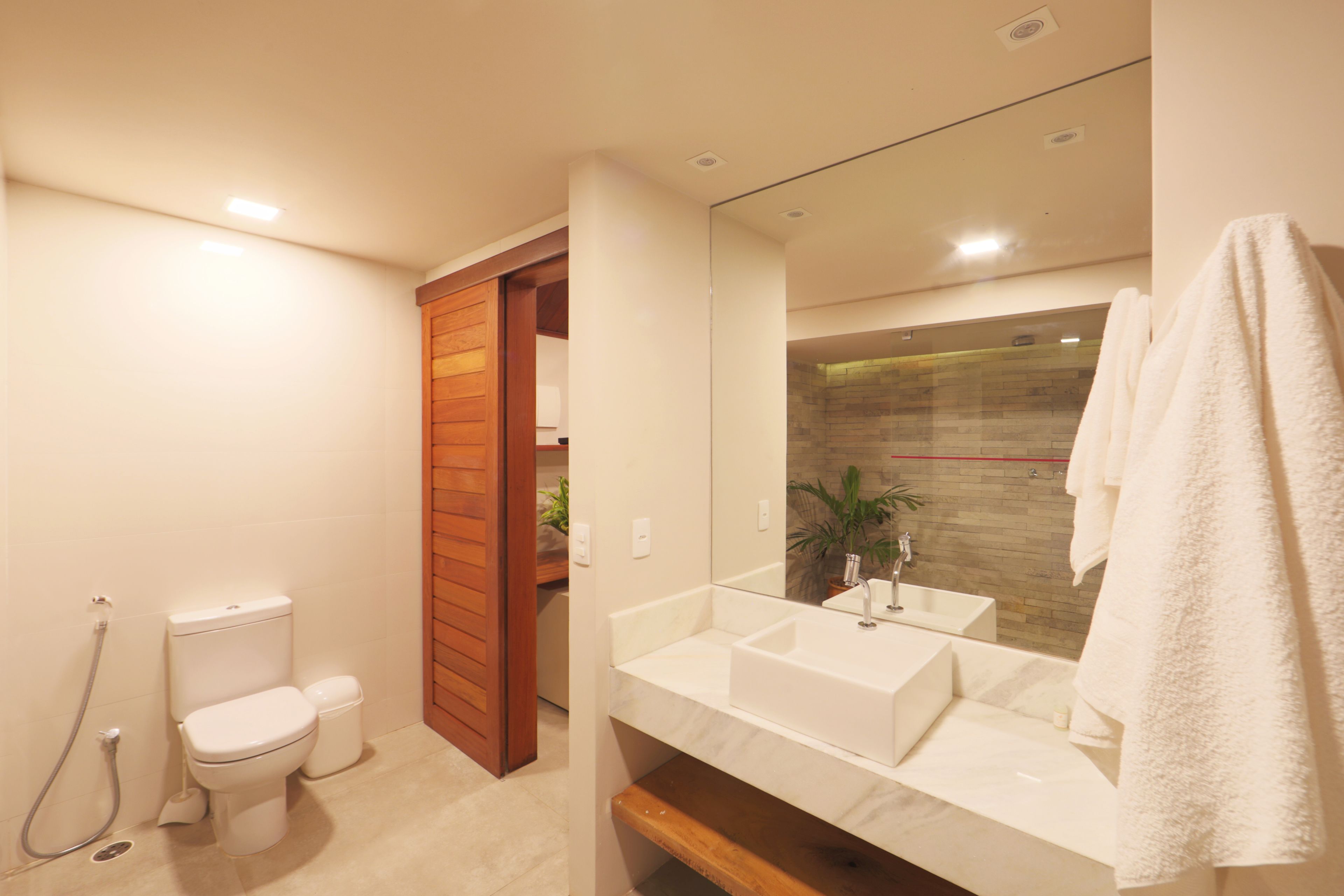 Ein modernes Badezimmer mit Toilette, Waschbecken und Dusche.