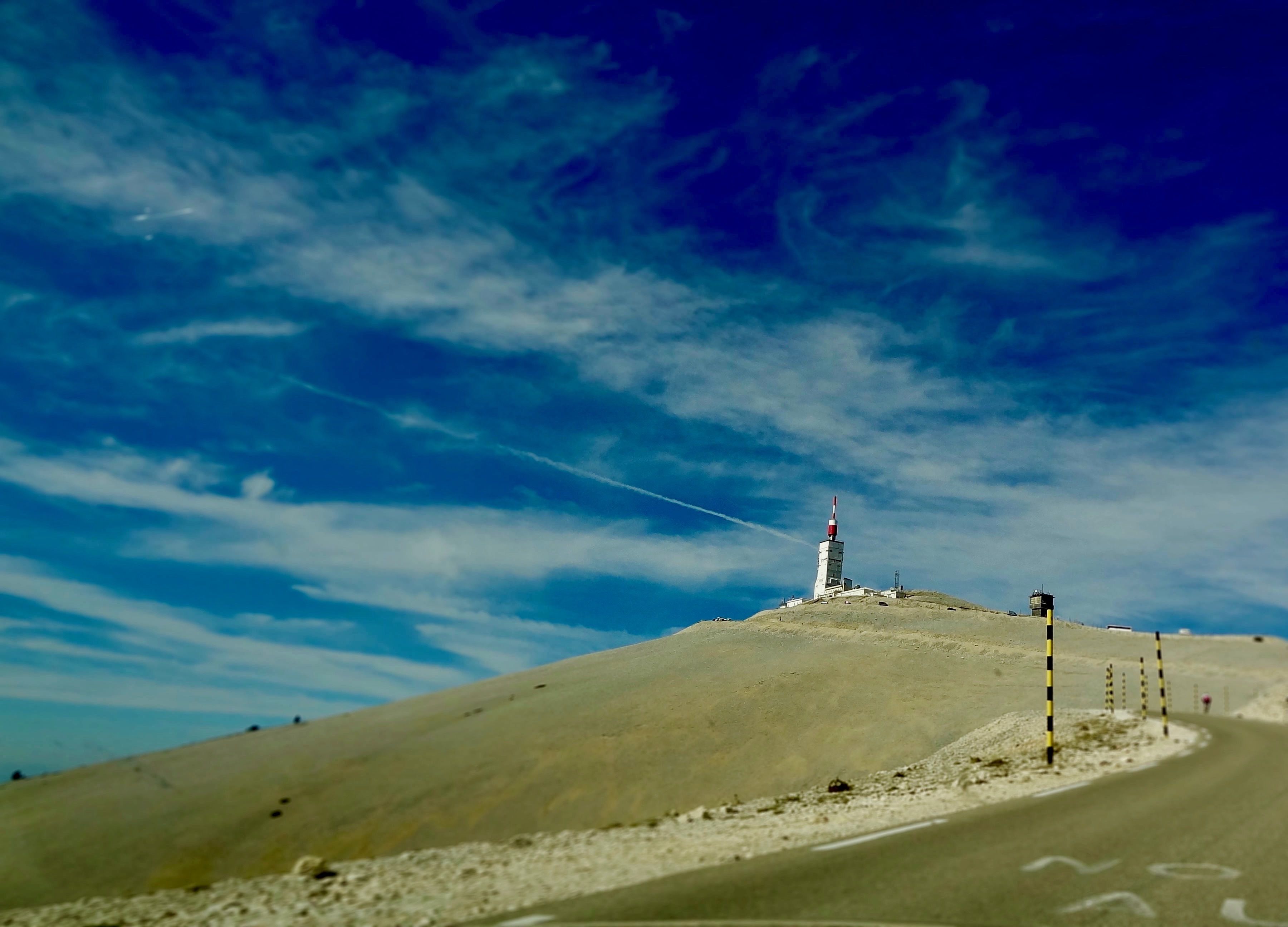A hill with a tall structure, possibly a communication tower, on top.
