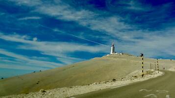 A hill with a tall structure, possibly a communication tower, on top.