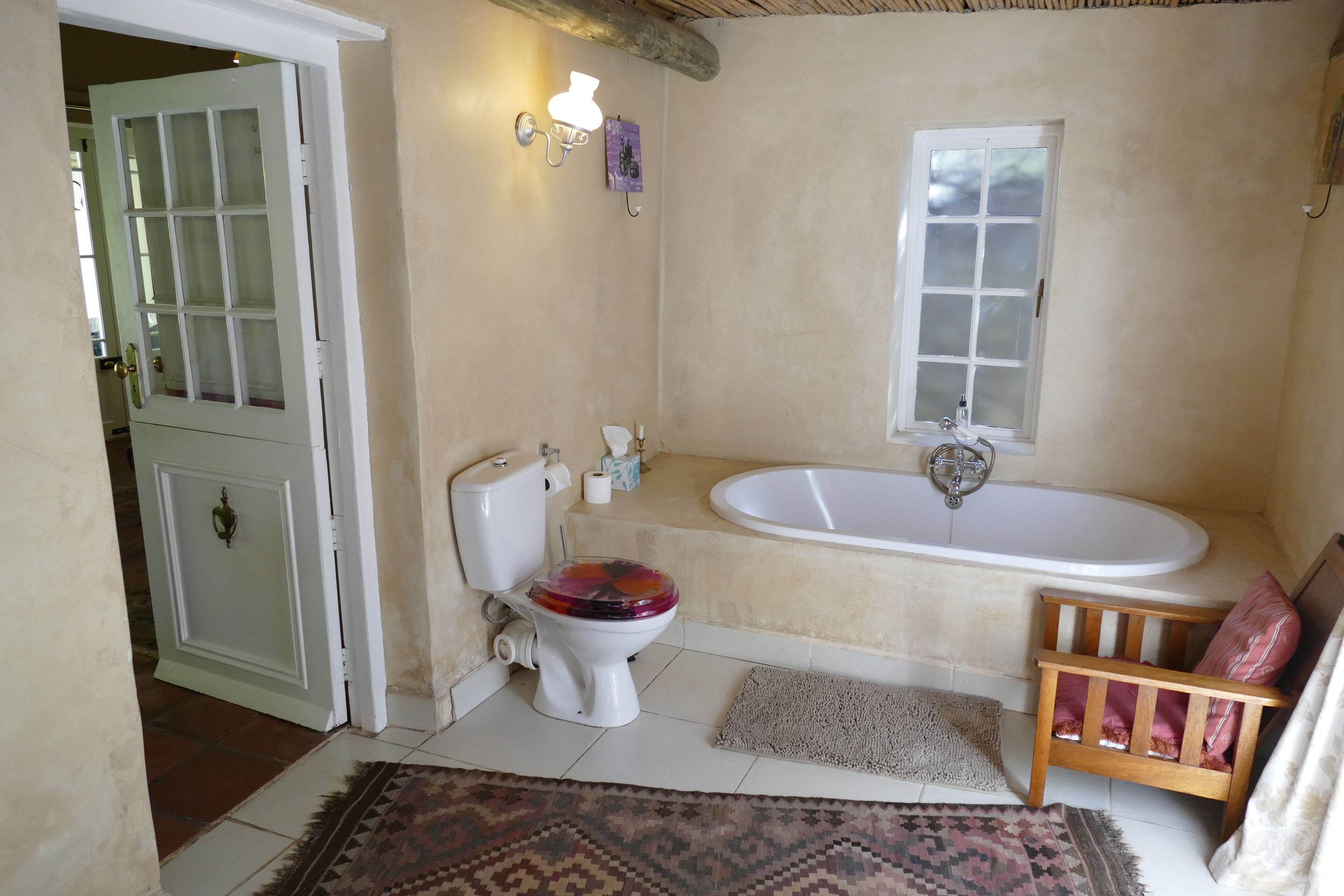 A bathroom with a toilet, sink, and bathtub.