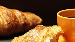 A croissant and a cup of coffee.