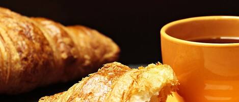 A croissant and a cup of coffee.