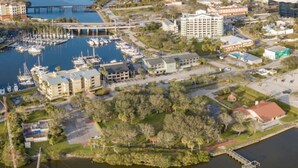 An aerial view of a marina with boats, a bridge, and surrounding buildings. - Boho Charm, Historic 1br -Steps to downtown (Melbourne)