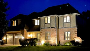 A two-story house with a brick facade, multiple windows, and a garage. - WOW ~ Watch the Sun Set from your Private Balcony ~ Family Gatherings  (Topeka)