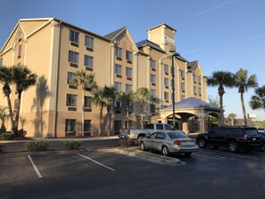 A multi-story hotel with a flat facade, large windows, and a covered entrance.
