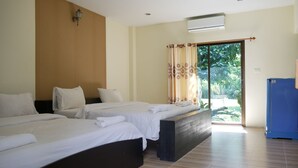 A hotel room with two beds, a large window with curtains, a ceiling fan, and a blue cabinet. - Aiyara Garden Resort (Chanthaburi)