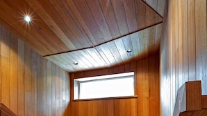 A wooden interior with a staircase, a skylight, and a wooden railing. - Le Chalets (Falls Creek)