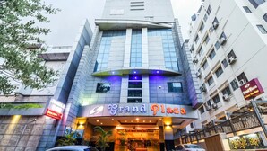 A hotel named Grand Plaza with a modern facade, large windows, and a prominent entrance. - Grand Plaza (Coimbatore)