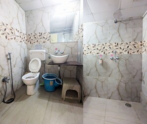 A bathroom with a toilet, bidet, sink, and shower. - Abode Homestay (Jaipur)