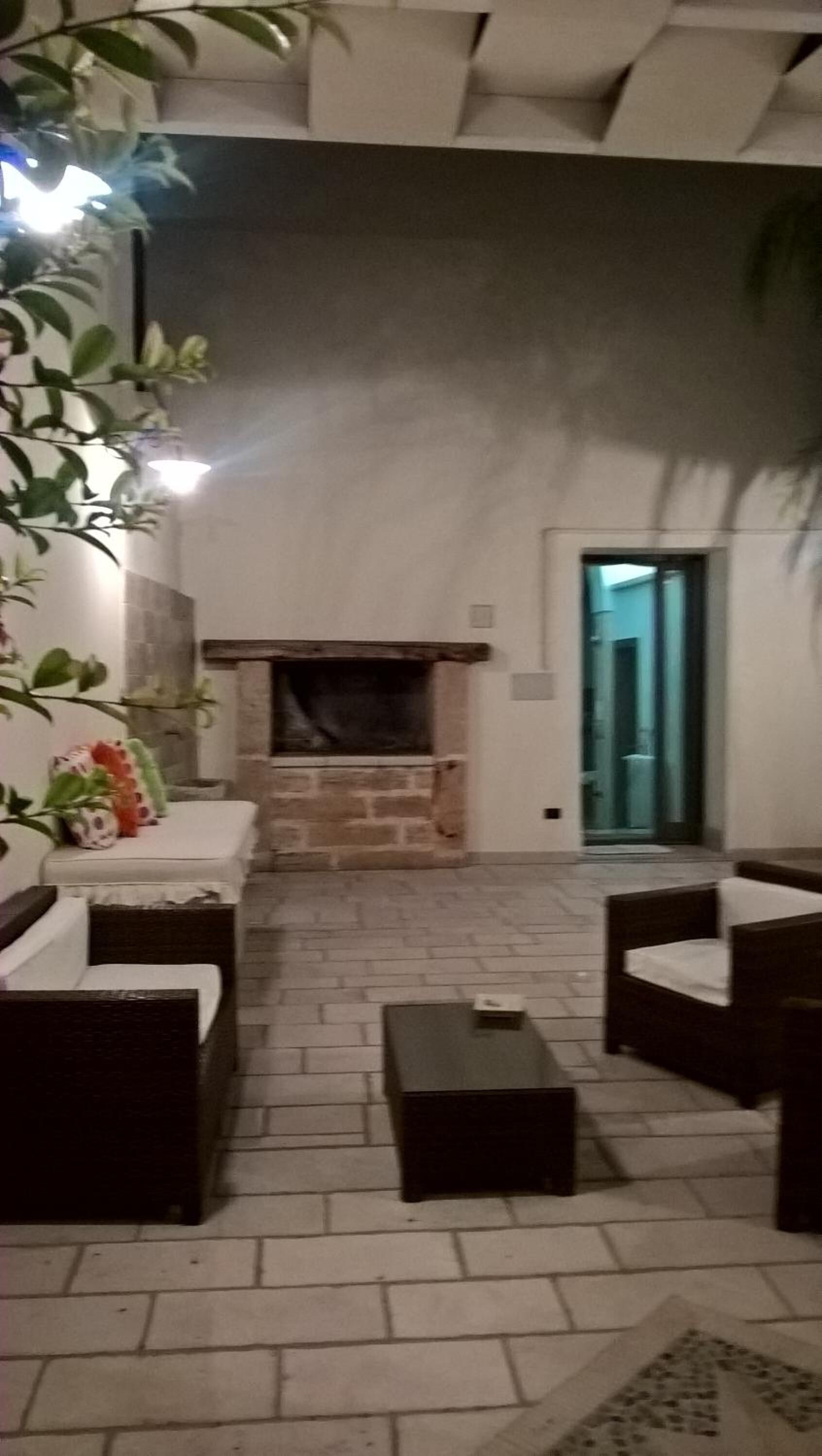 A cozy indoor seating area with a fireplace, sofas, and a coffee table.