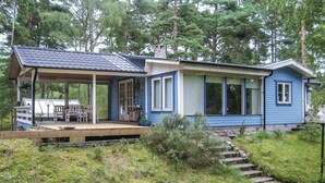 A two-story house with a covered porch and a stone staircase leading to the entrance. - 2 bedroom amazing home in Yngsjö (Yngsjö)