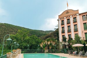 A hotel named 'LES THERMES' with a pool, surrounded by greenery and hills. - Le Grand Hôtel (Molitg-les-Bains)