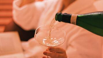 A person pouring a liquid from a bottle into a glass.