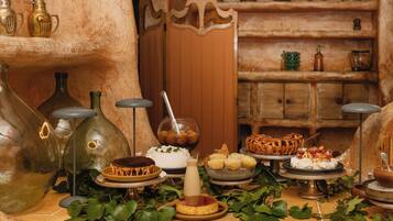 A traditional setting with a stone wall, a wooden door, and shelves with pottery.