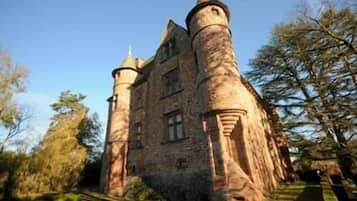A historic stone castle with multiple towers and a central courtyard.