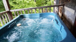 A hot tub with two control panels and a wooden deck railing. - SERENITY IN THE MOUNTAINS - Private-view-convenient-unique-hot tub-ev charging (Sevierville)