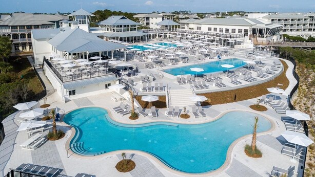 A resort with multiple swimming pools, sun loungers, and a covered area with umbrellas. - Last minute discount July 5-11!  Watercolor Camp district 5BR w/ Pool & Spa (Santa Rosa Beach)