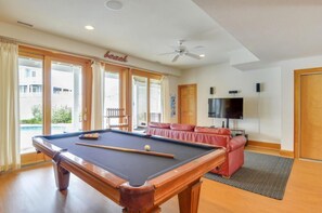 A pool table in a room with a sofa, a television, and a ceiling fan. - Ocean-side 6BR Corolla escape with private pool, hot tub & game room BI-20 (Corolla)