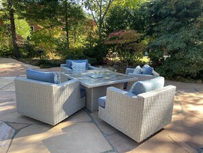 A patio with wicker furniture and a glass-top table. - Charming Riverside Retreat (Gasquet)