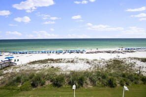 A beach with umbrellas and a wooden walkway. - Kick back and relax, PARADISE AWAITS! 203 Destin Seafarer (Destin)