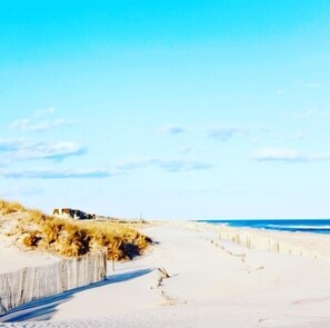A beach with a sandy path leading to a building. - Autumn in East Hampton! Private Beach Community, Hot Tub, Pirate Ship and More! (East Hampton)