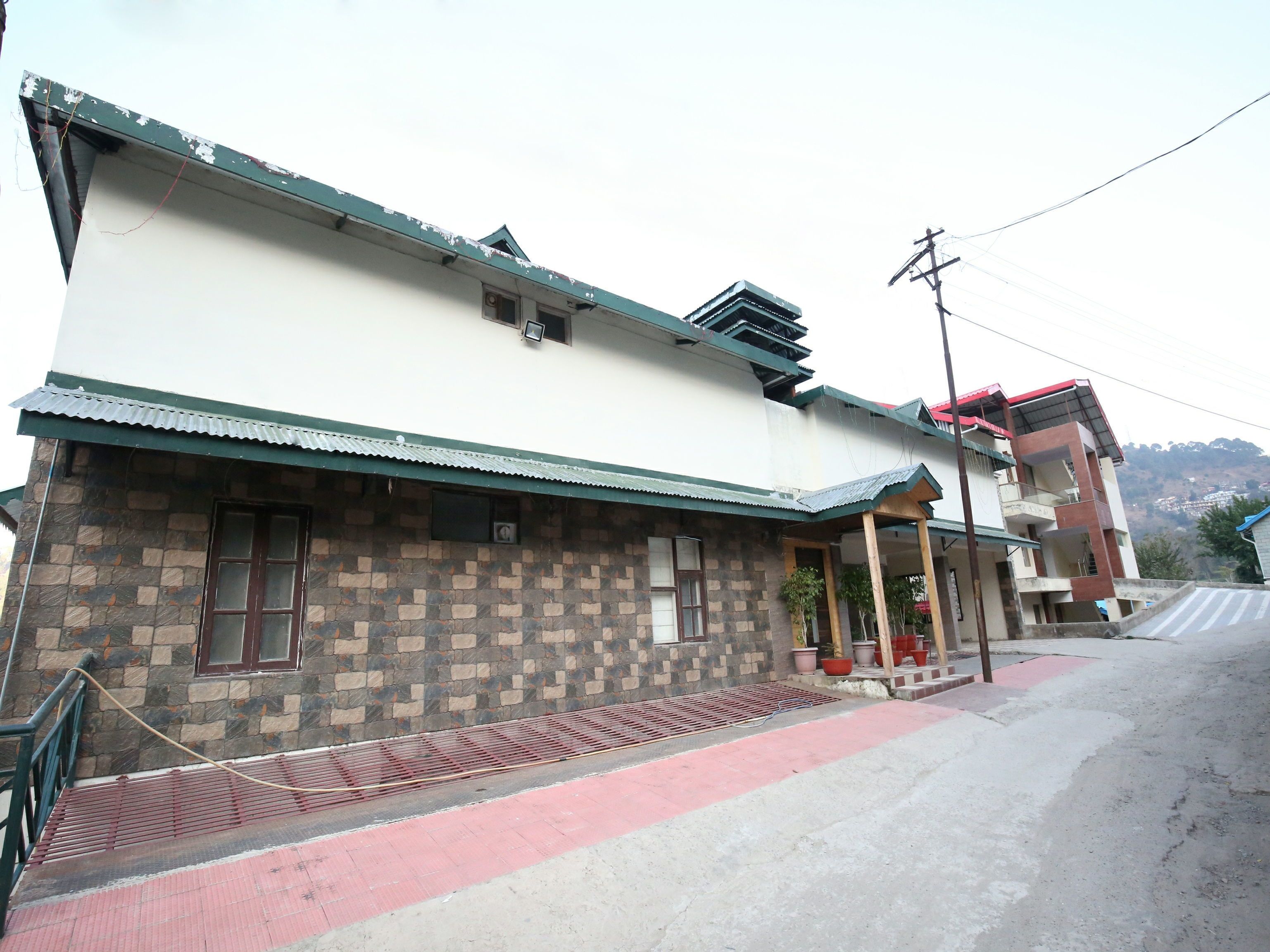 A two-story building with a stone facade and a flat roof.