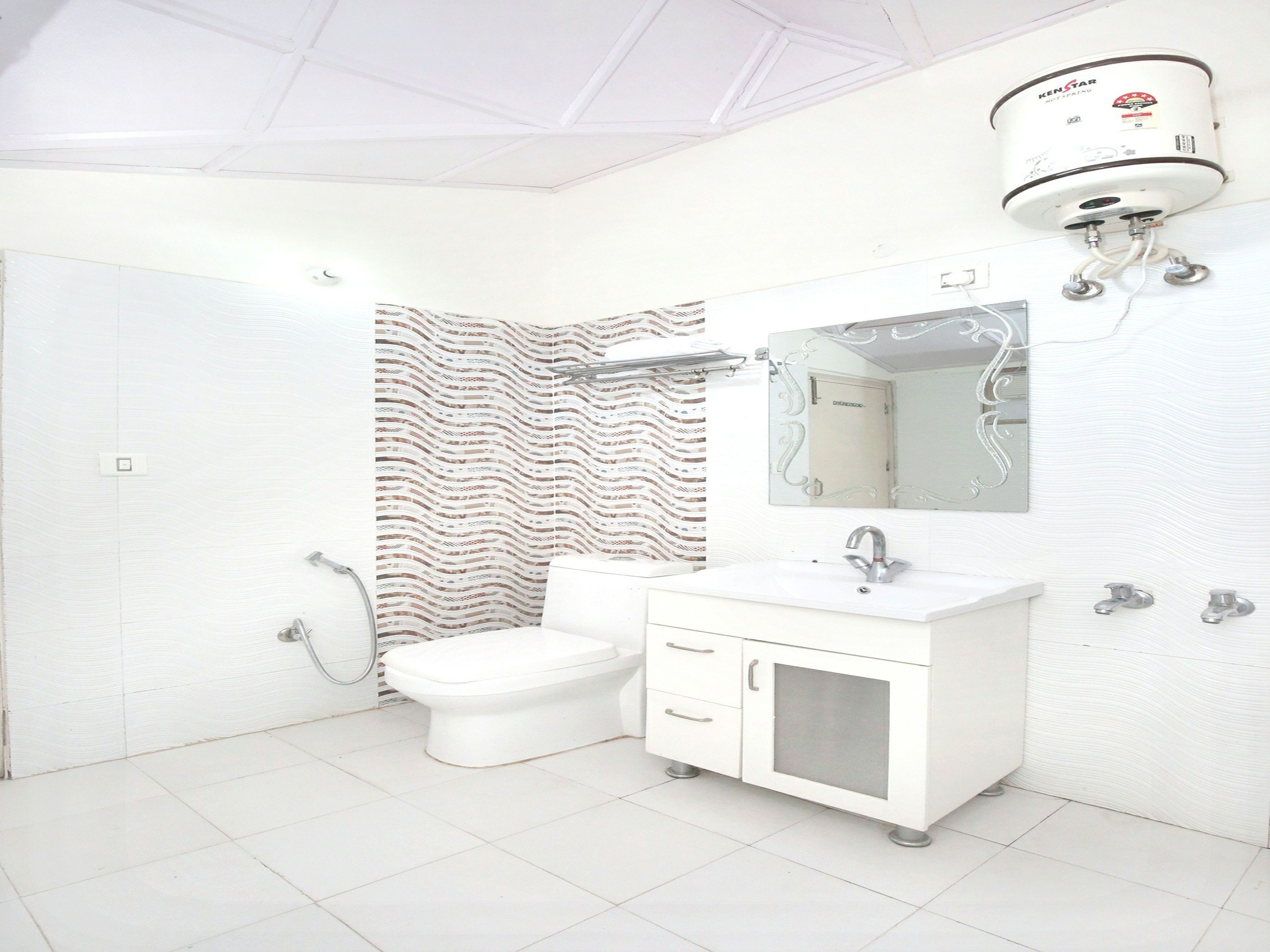 A bathroom with a toilet, sink, and shower.