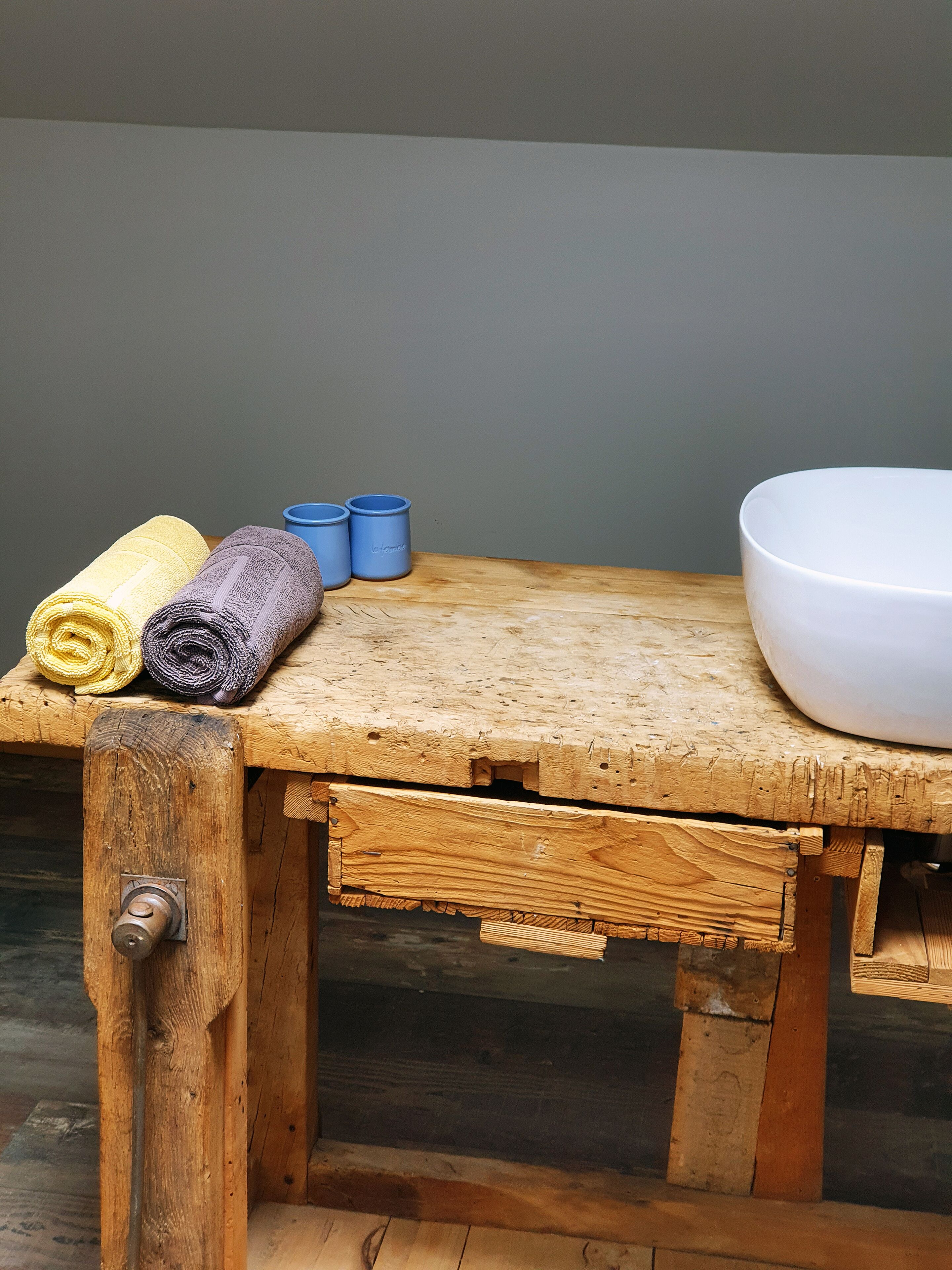 Une table en bois avec des serviettes et un lavabo.