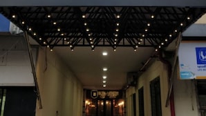 A sign for Park Street Bed & Breakfast with a covered entrance and string lights. - 10 Park Street Hotel & Banquets (Gorakhpur)