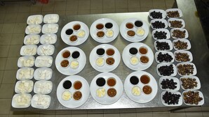 A table with various food items and condiments arranged in rows. - Serenity Bungalows (Kemer)