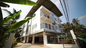 A multi-story building with a flat roof, balconies, and a covered entrance area. - Indeevaram Residency (Thiruvananthapuram)
