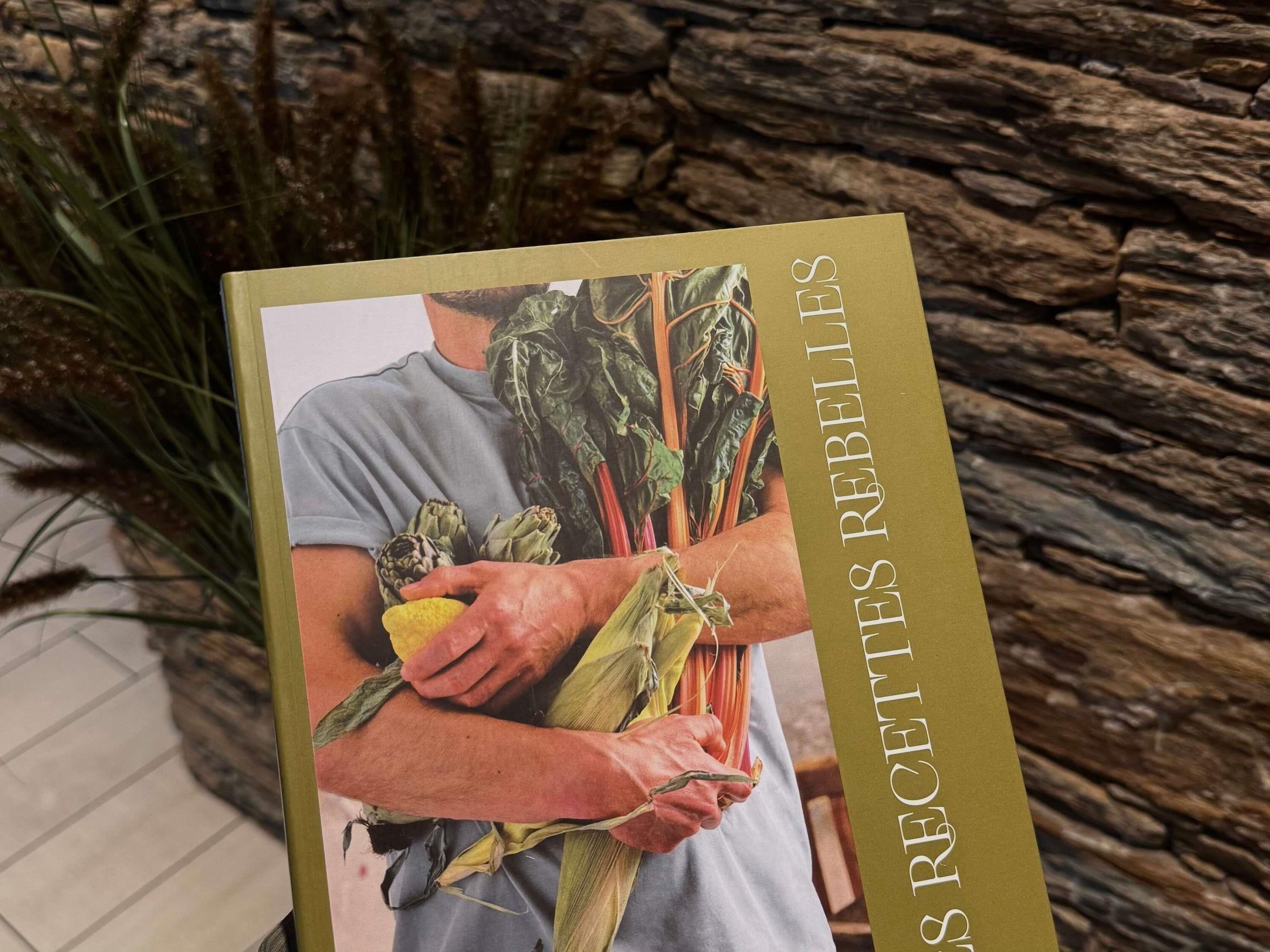 A book titled 'RECEPIES REBELLES' with a person holding vegetables.