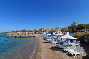 On the beach, sun-loungers, beach umbrellas