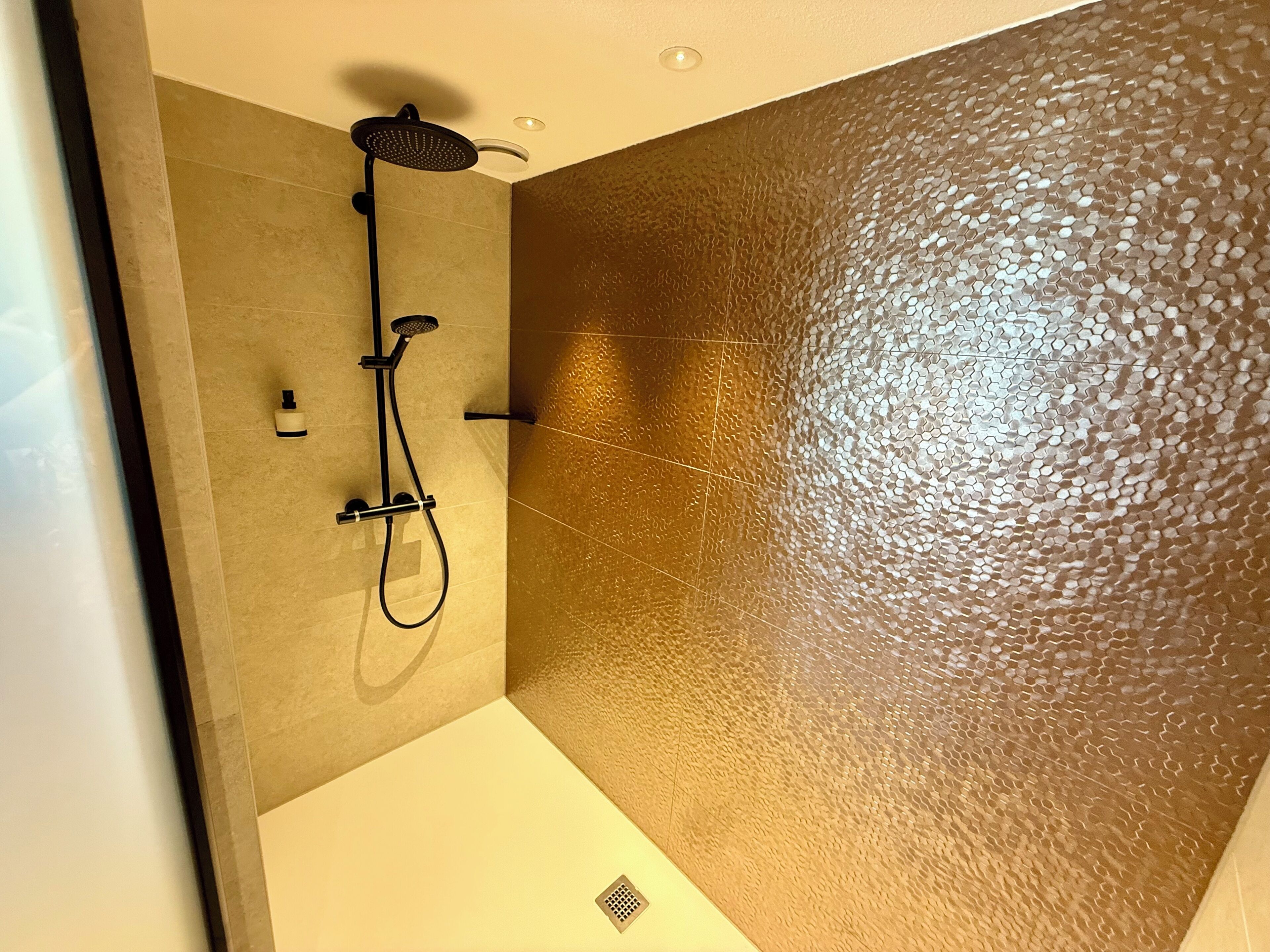 Un baño moderno con ducha, inodoro y lavamanos.