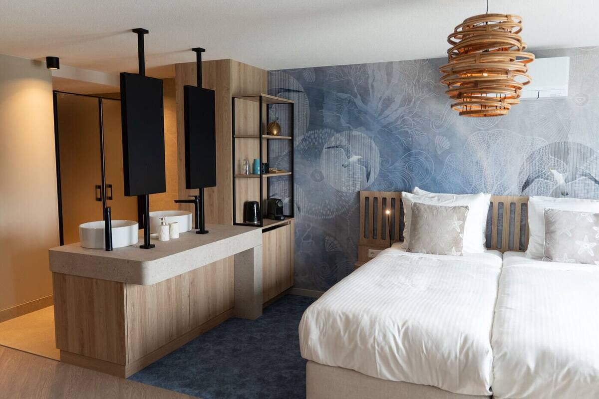 A modern bedroom with a built-in vanity, a large bed, and a unique wall mural.