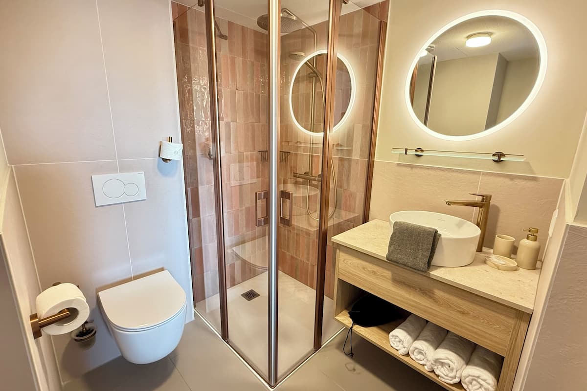 shower, rainfall showerhead, hair dryer, towels